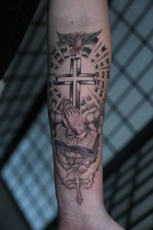 Benson Carlos black and gray religious tattoo with cross on forearm in Hawaii